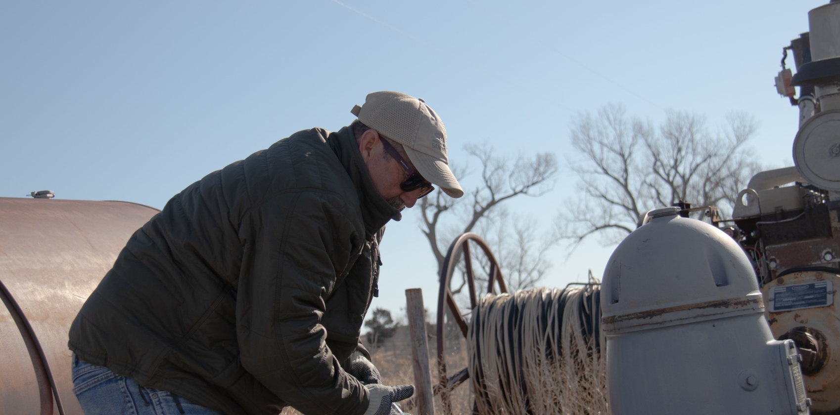 Ken Dawson measuring a well