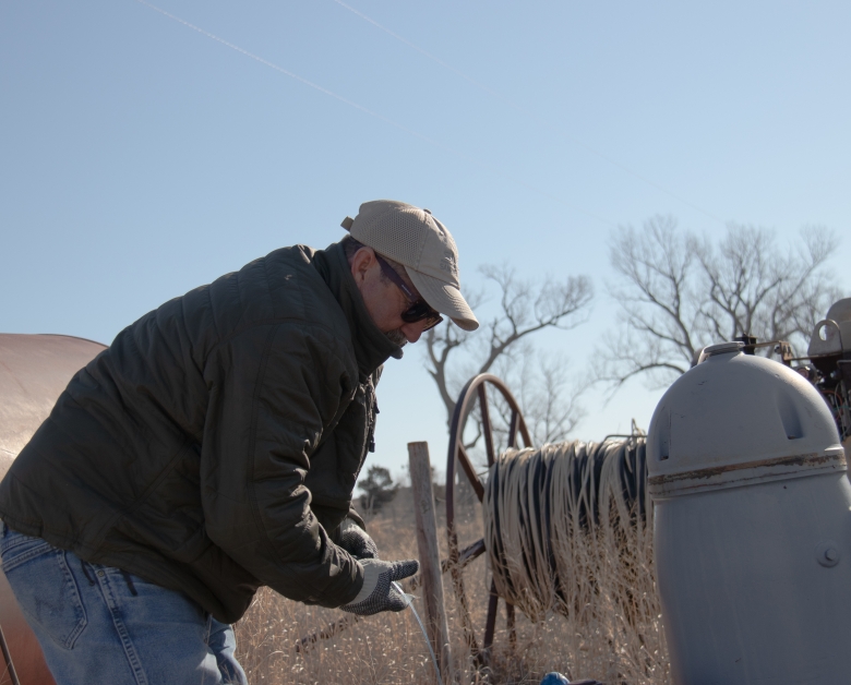 Ken Dawson measuring a well